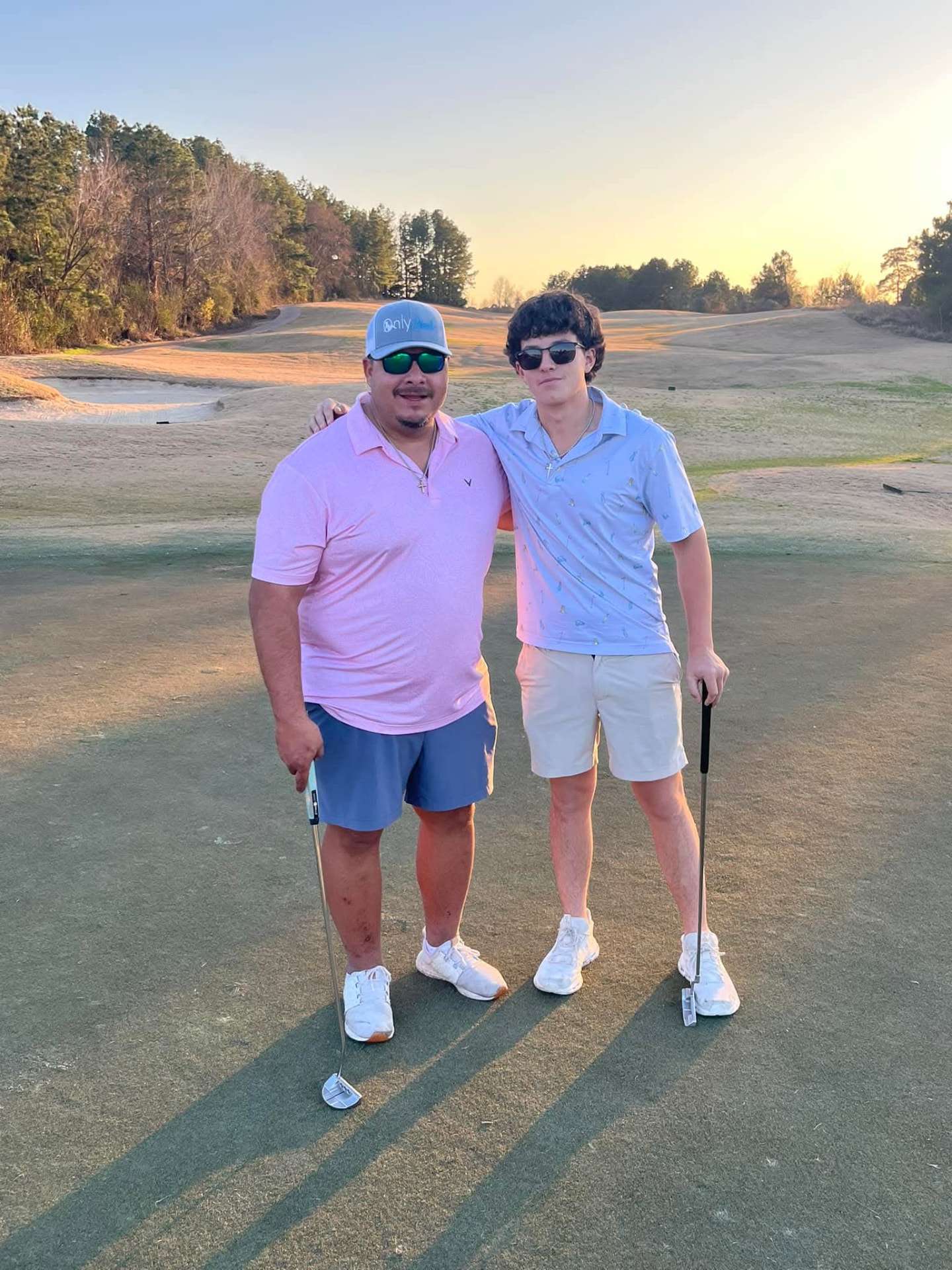 Christian Doggett with a young family member on the golf course