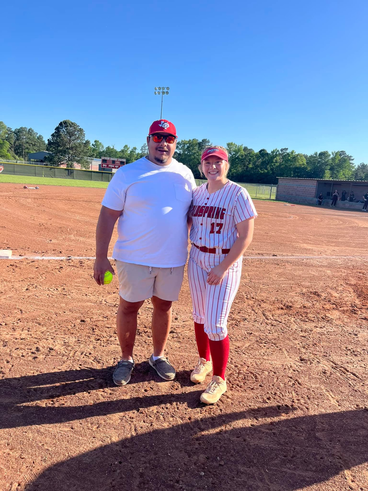 Christian Doggett with a young softball athlete at a Coldspring ball field